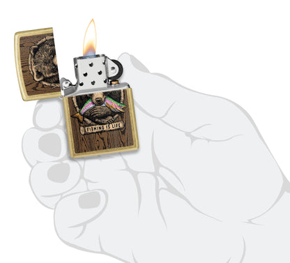 Zippo Rietveld Fishing is Life Design lit in hand.