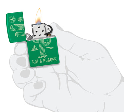 Zippo Not a Hugger Design Grass Green Matte Windproof Lighter lit in hand.