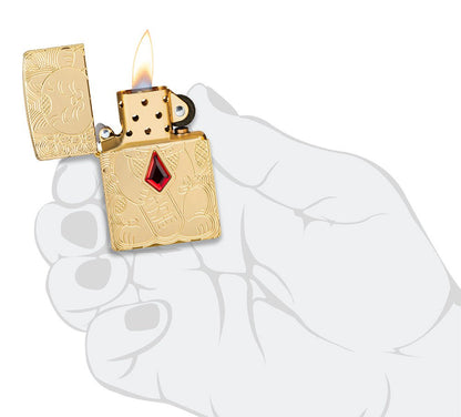 Lucky Cat Design Emblem Attached ArmorÂ® High Polish Brass Windproof Lighter lit in hand.