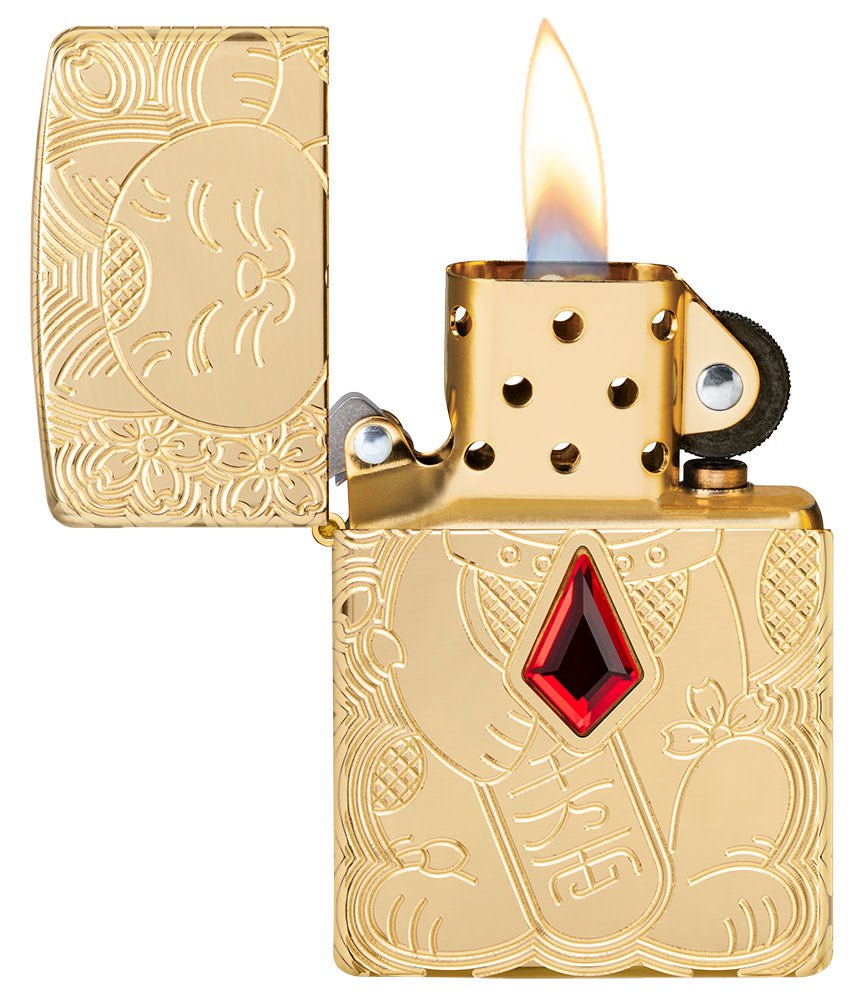 Lucky Cat Design Emblem Attached ArmorÂ® High Polish Brass Windproof Lighter with its lid open and lit.