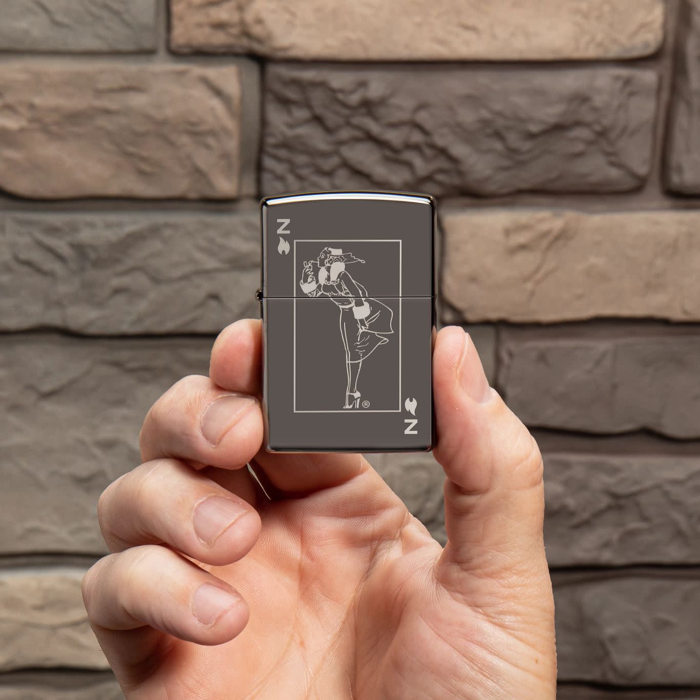 Lifestyle image of Windy Design Card Black IceÂ® Windproof Lighter in hand.